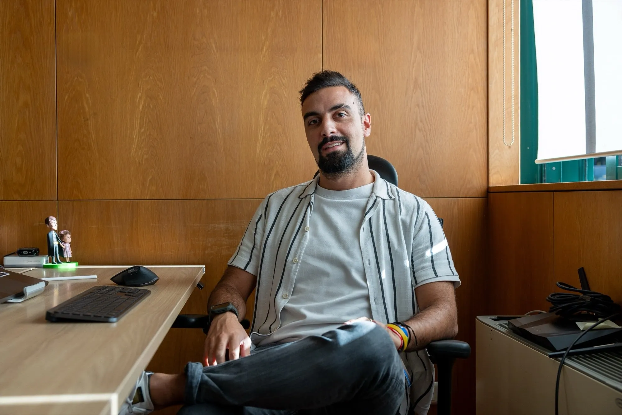 David Olim smiling, seated in a wood-panelled office