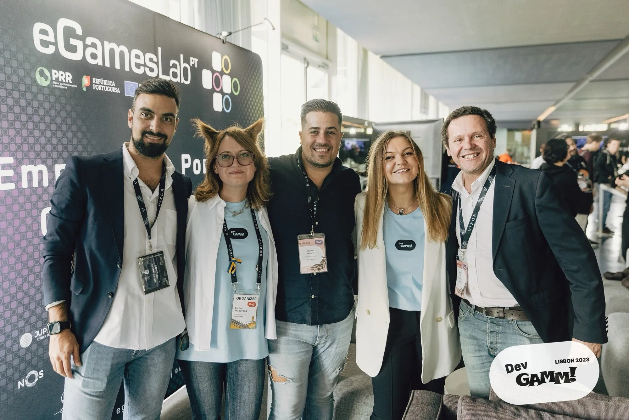 David Olim with members of the eGames Lab delegation in front of the eGames Lab banner