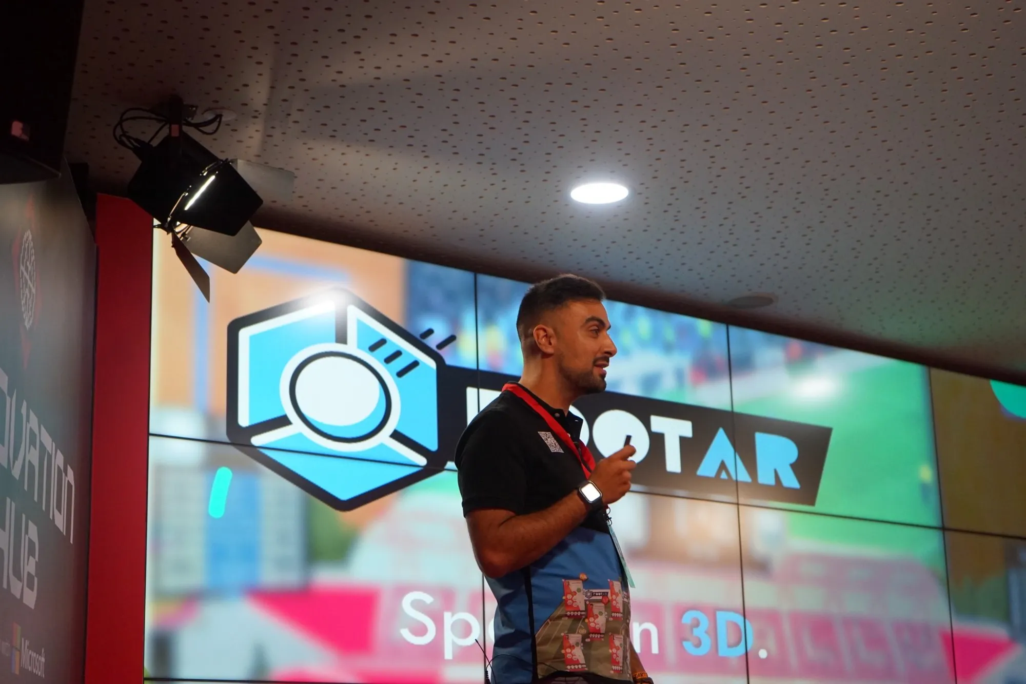 David Olim on stage in front of a large FootAR screen