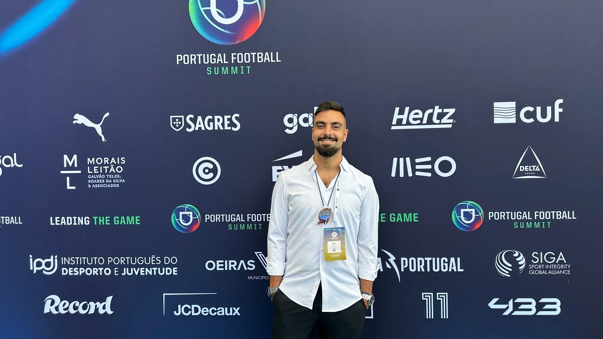 David Olim in front of the Portugal Football Summit sponsor wall