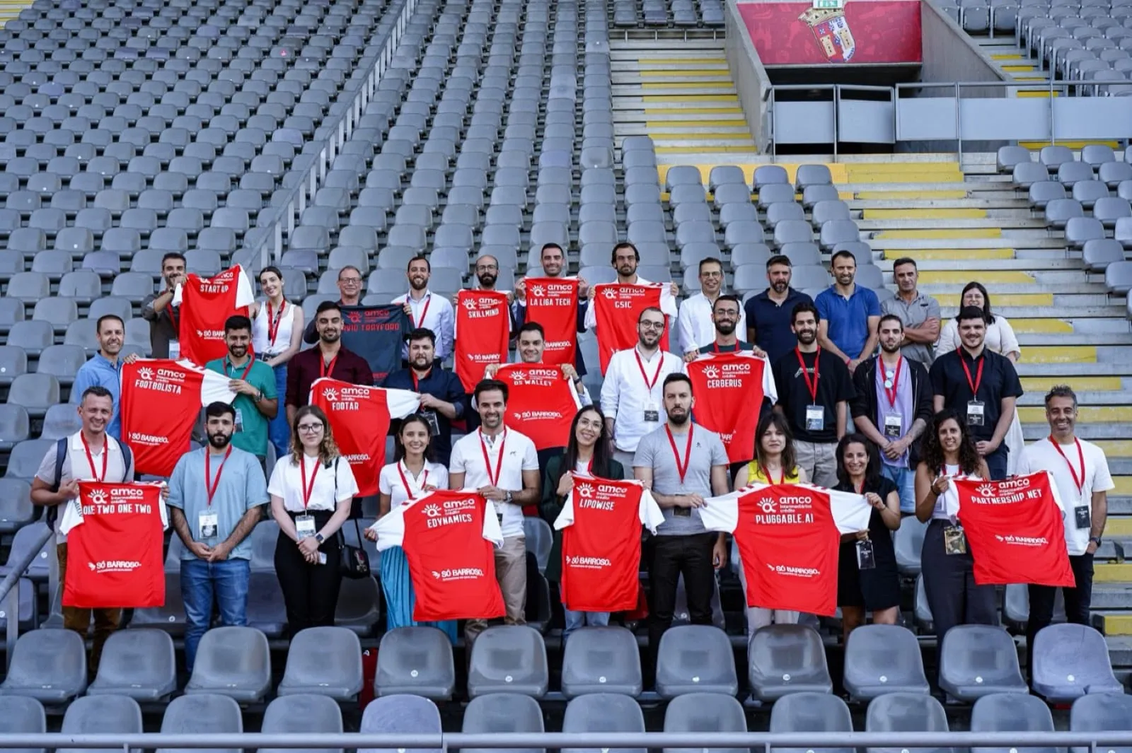 The SC Braga Innovation Hub cohort in the stadium stands, holding SC Braga shirts