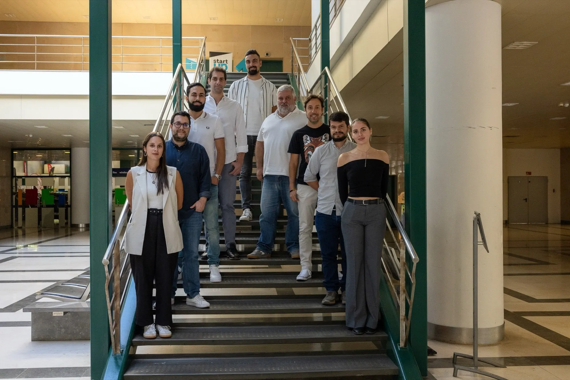 The FootAR team standing together on a staircase